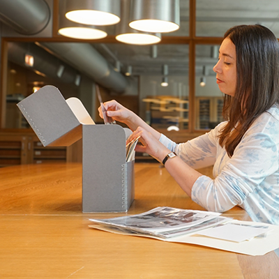 Archivist at table with archive box